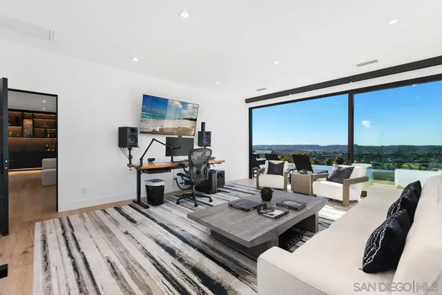 a living room with furniture and large window