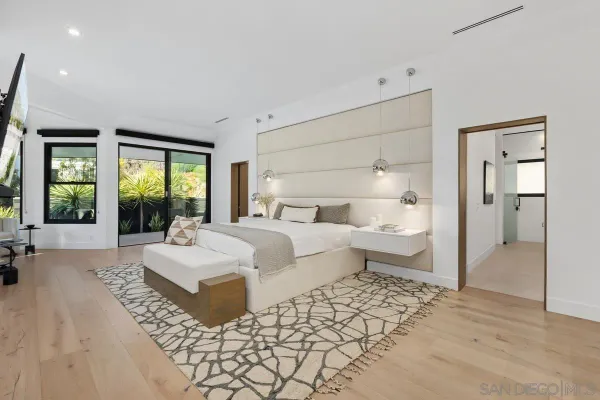 a bedroom with a large bed and a large window