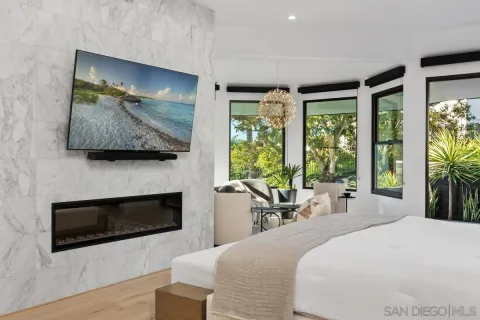 a bedroom with a bed and a flat screen tv