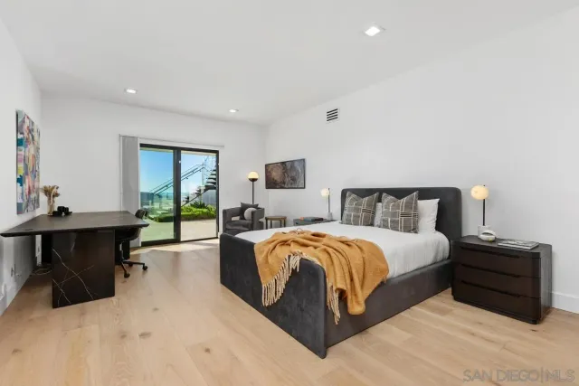 a spacious bedroom with a bed and a desk