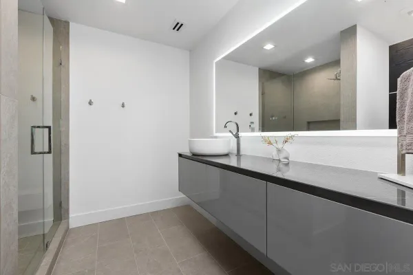 a bathroom with a double vanity sink and mirror