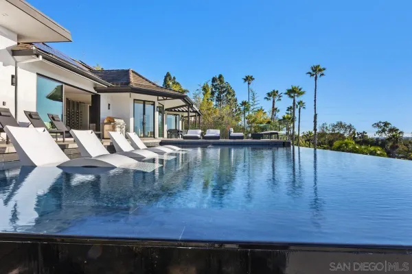 a view of a lake with couches chairs
