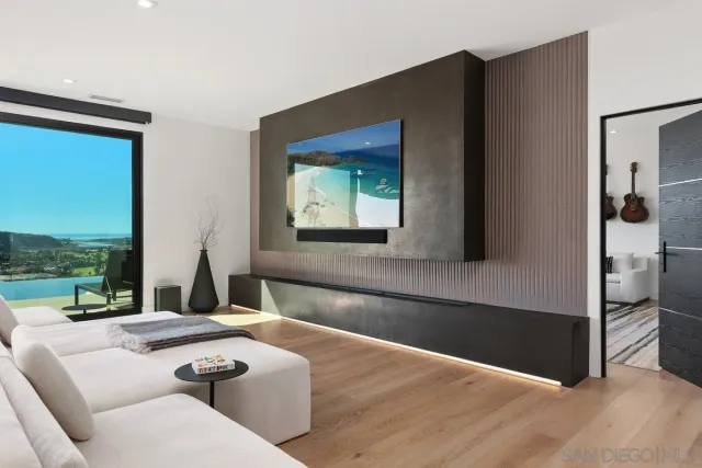 a living room with a couch and a floor to ceiling window