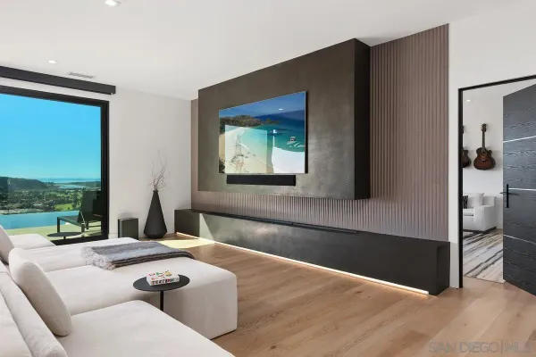 a living room with a couch and a floor to ceiling window