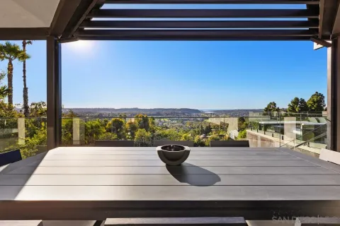 a view of a balcony with floor to ceiling window next to a yard