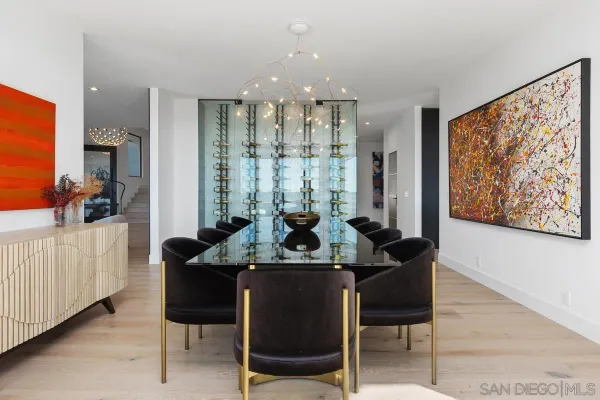 a view of a dining room with furniture and chandelier