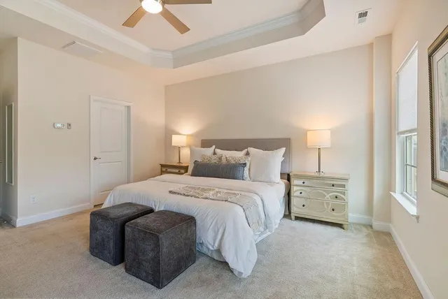 a bedroom with a bed and a ceiling fan