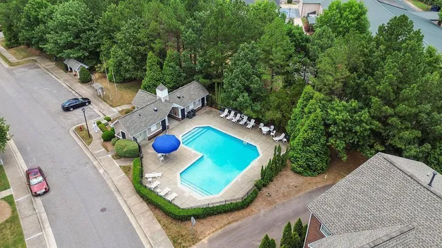 an aerial view of a house roof deck with couches and wooden floor