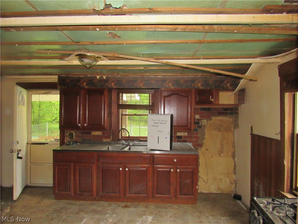 3462 Niles Carver Road Mineral Ridge, OH 44440 - Photo 6 of 33 Kitchen featuring backsplash, sink, and light tile floors