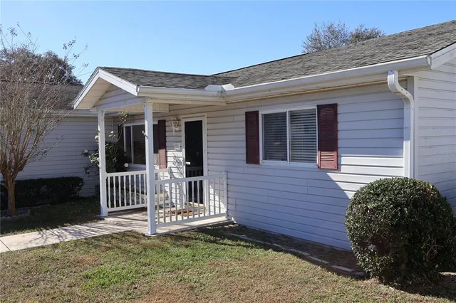 a view of a house with a yard and wooden fence