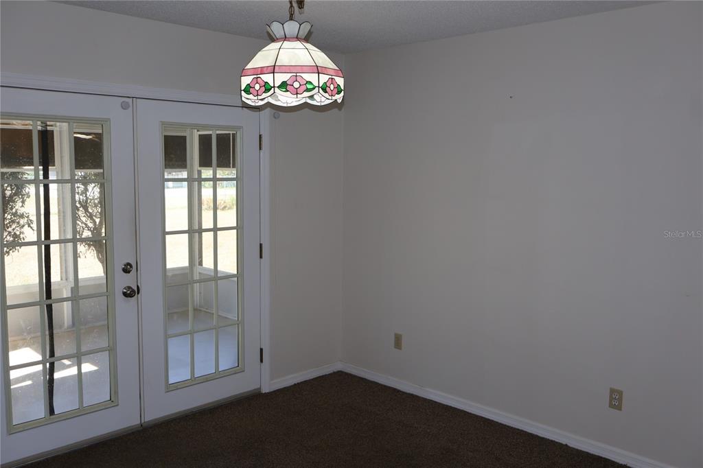6522 Southwest 60th Court Ocala, FL 34474 - Photo 10 of 23 wooden floor in an empty room with a window