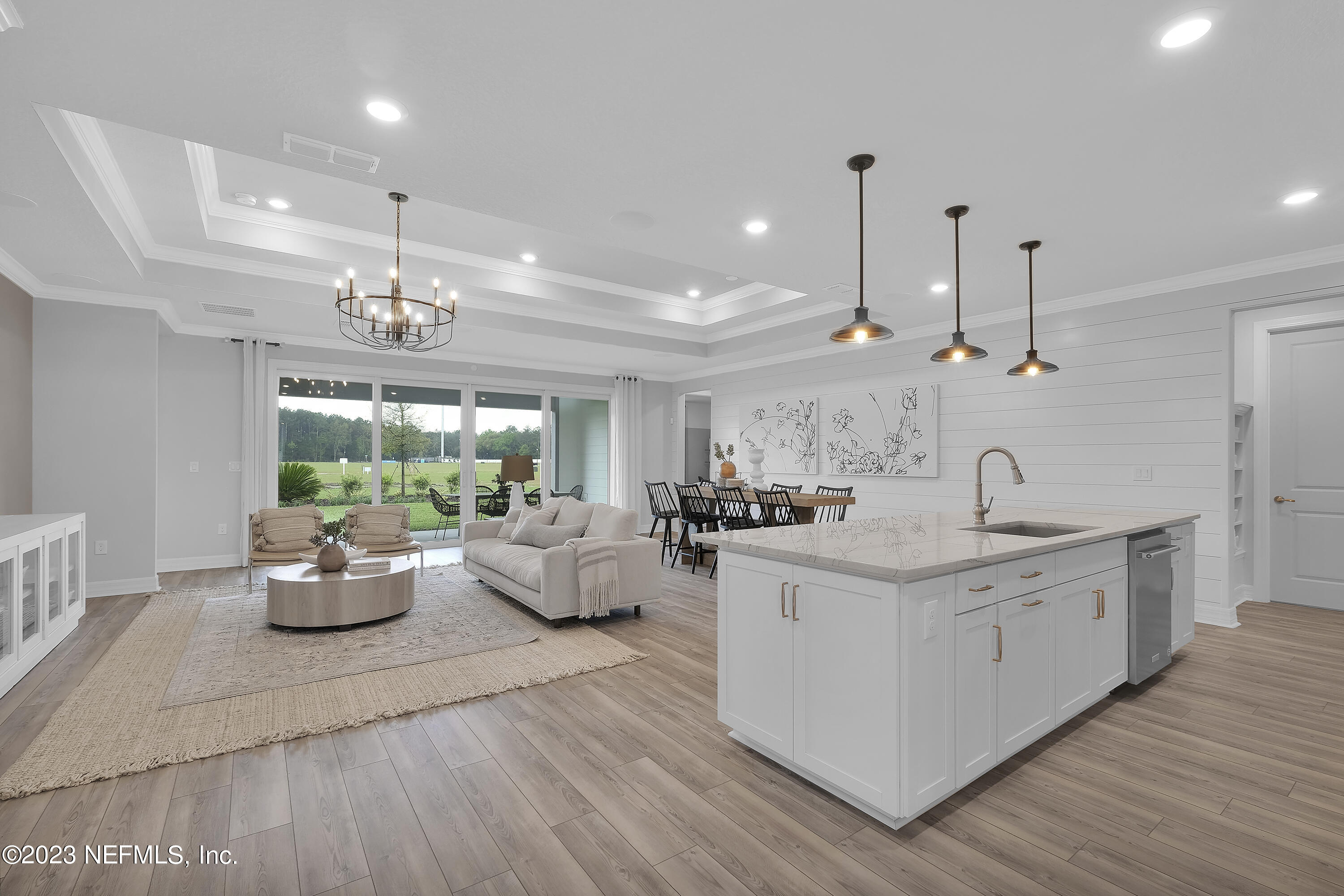 12435 Clapboard Blf Trail Jacksonville, FL 32226 - Photo 6 of 30 a kitchen with kitchen island granite countertop a sink cabinets and wooden floor