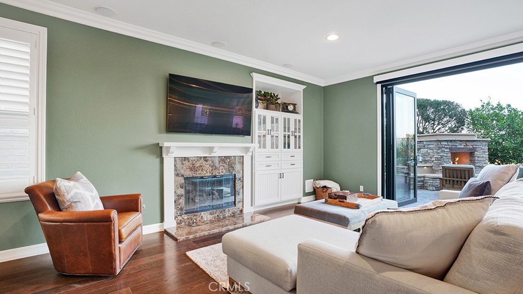473 Camino Flora Vista San Clemente, CA 92673 - Photo 11 of 59 a living room with furniture a fireplace and a flat screen tv