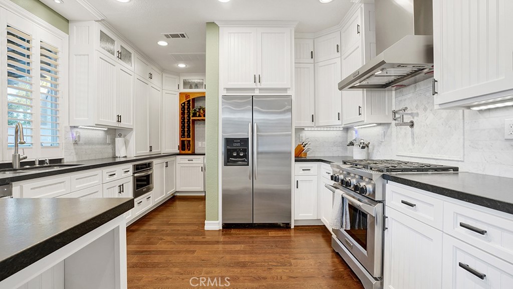473 Camino Flora Vista San Clemente, CA 92673 - Photo 14 of 59 a kitchen with stainless steel appliances a stove a sink and a refrigerator