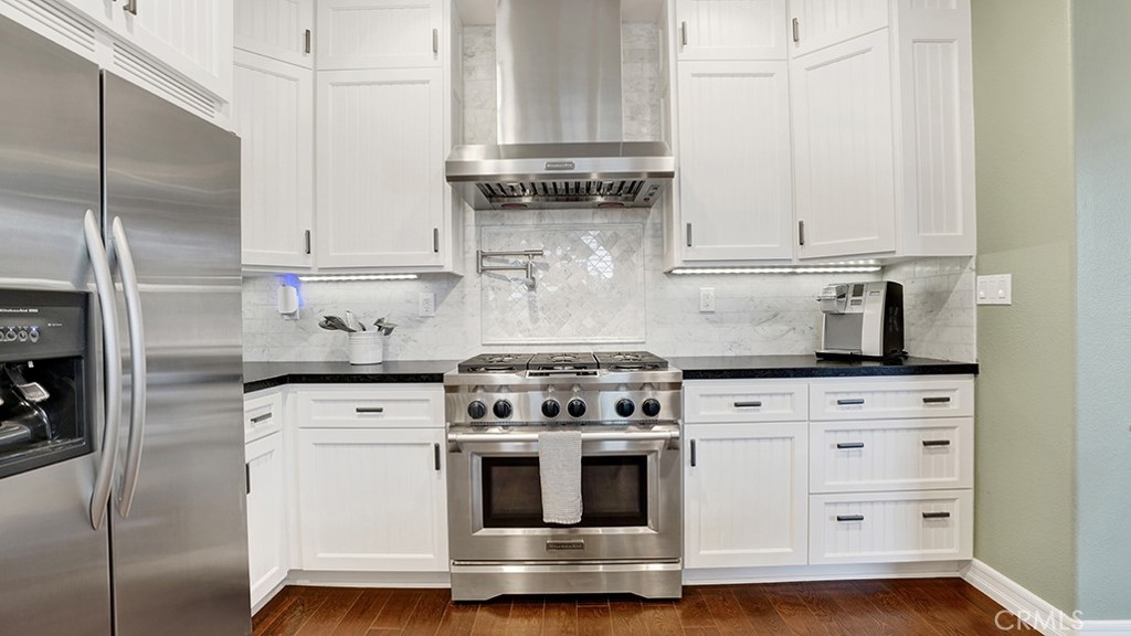 473 Camino Flora Vista San Clemente, CA 92673 - Photo 15 of 59 a kitchen with granite countertop white cabinets and white appliances
