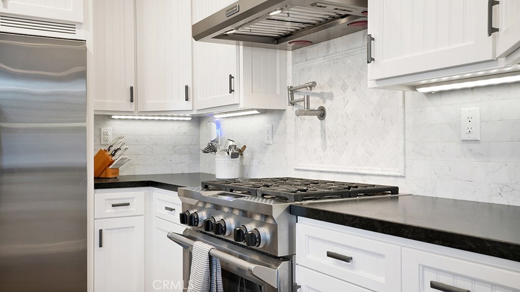 473 Camino Flora Vista San Clemente, CA 92673 - Photo 16 of 59 a white stove top oven sitting inside of a kitchen