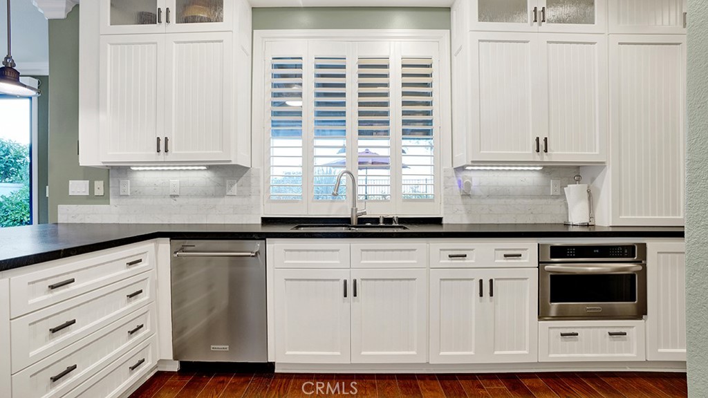 473 Camino Flora Vista San Clemente, CA 92673 - Photo 17 of 59 a kitchen with granite countertop white cabinets and white appliances