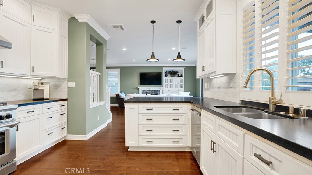 473 Camino Flora Vista San Clemente, CA 92673 - Photo 19 of 59 a kitchen with stainless steel appliances kitchen island granite countertop a sink a stove and a refrigerator