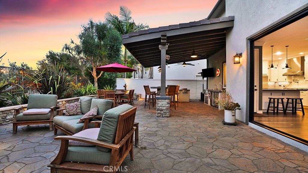 473 Camino Flora Vista San Clemente, CA 92673 - Photo 38 of 59 a view of a patio with a dining table and chairs with wooden floor
