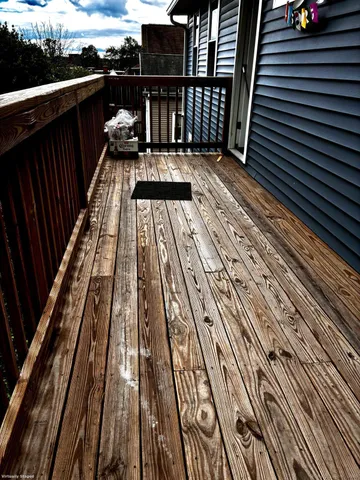 a view of balcony with wooden floor