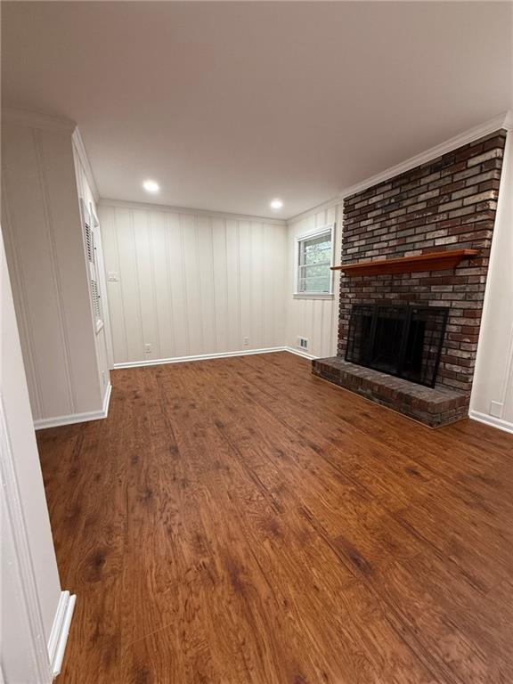 3085 Stantondale Drive Atlanta, GA 30341 - Photo 9 of 20 an empty room with wooden floor fireplace and windows