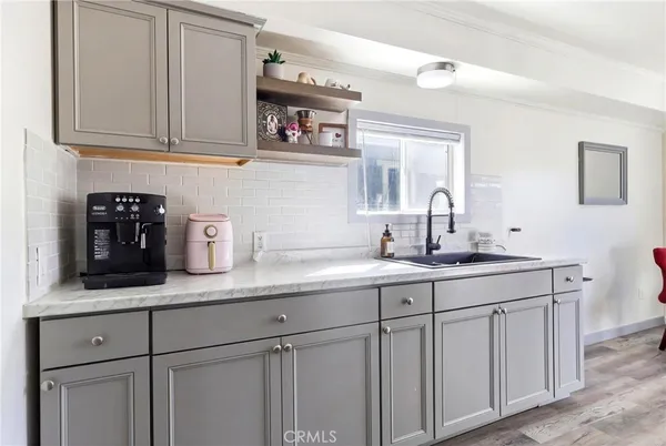 a kitchen with a refrigerator and a sink