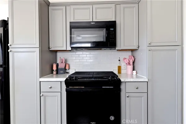 a kitchen with a refrigerator and a sink