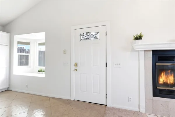 a view of a kitchen with white cabinets and wooden floor