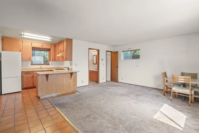 a view with kitchen with furniture and refrigerator