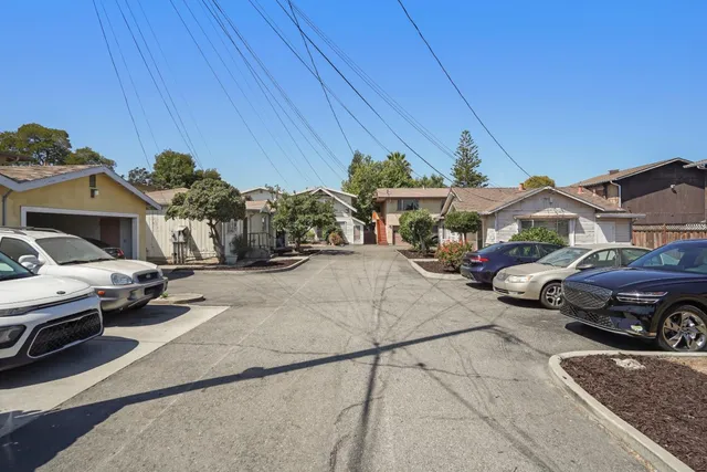 a couple of cars parked in front of a house