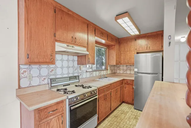a kitchen with a stove sink and refrigerator