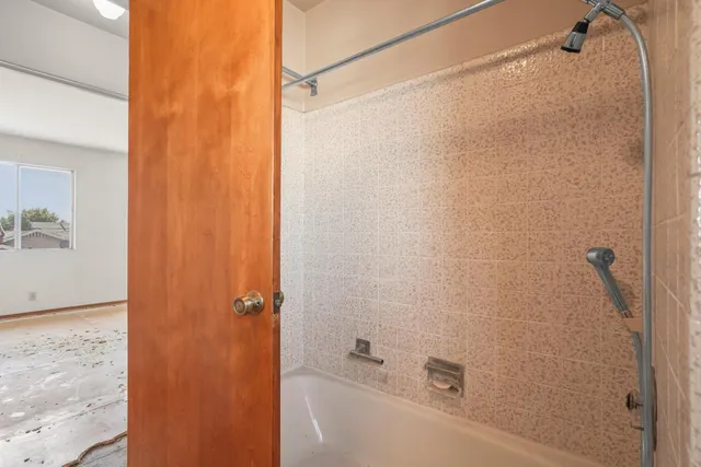 a bathroom with a shower and a bath tub