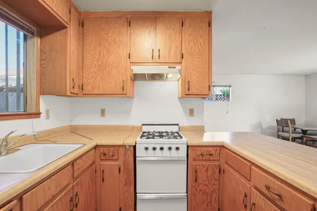 a kitchen with appliances a sink and a cabinets
