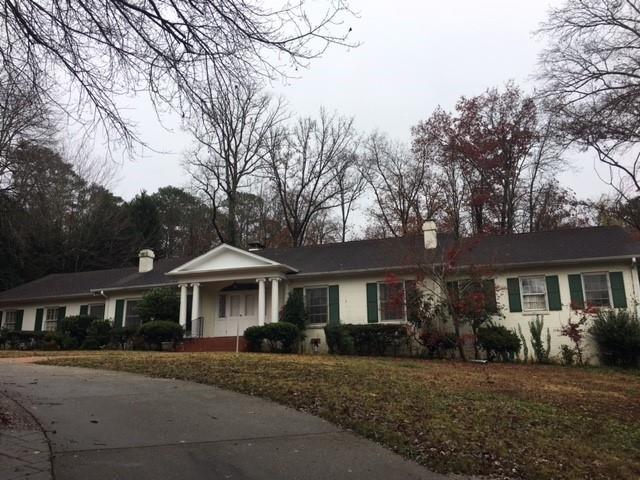 406 Pineland Road Northwest Atlanta, GA 30342 - Photo 1 of 1 a front view of a house with a garden