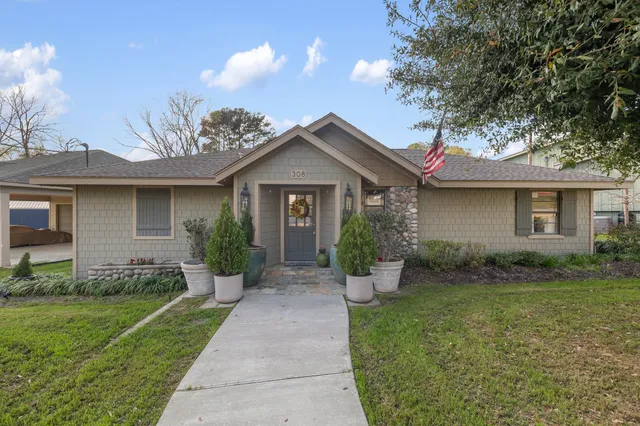 a front view of a house with garden