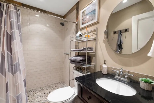 a bathroom with a sink toilet and shower