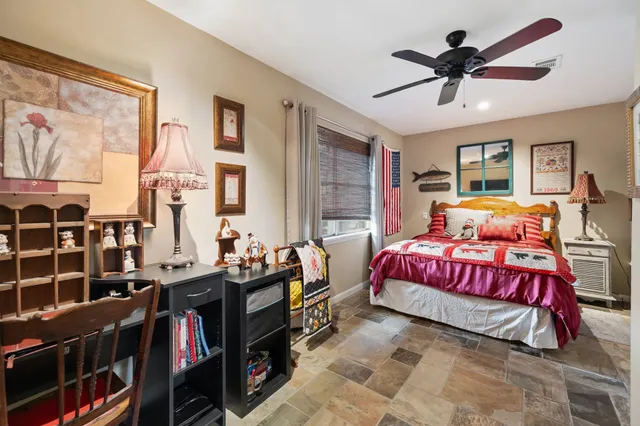 a bedroom with a bed furniture and a chandelier