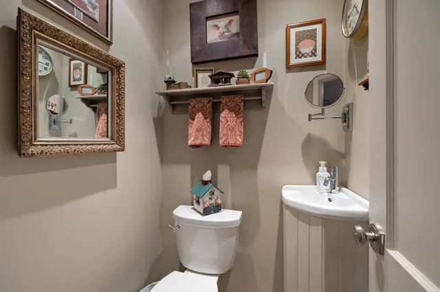 a bathroom with a toilet sink and mirror