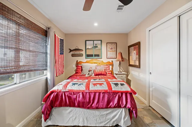 a bedroom with a bed and window