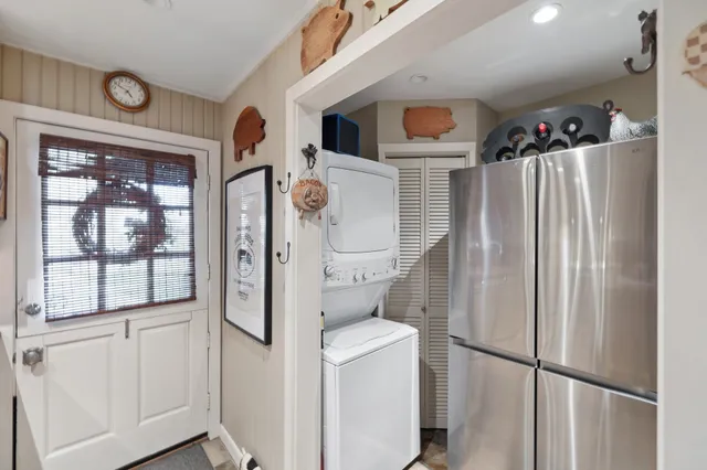 a bathroom with a refrigerator a sink and a window