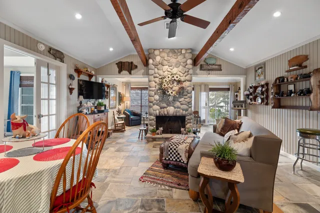 a living room with furniture a fireplace and a chandelier
