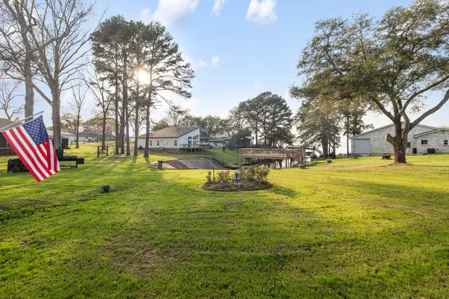 a view of a swimming pool with a garden and trees