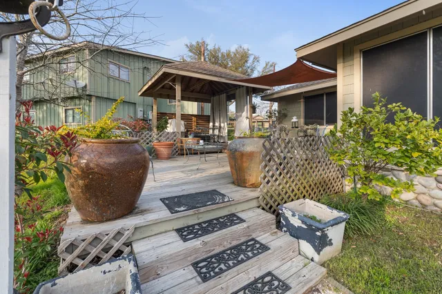 a view of a patio with table and chairs and potted plants