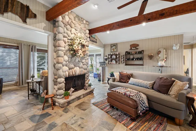 a living room with furniture a fireplace and a chandelier