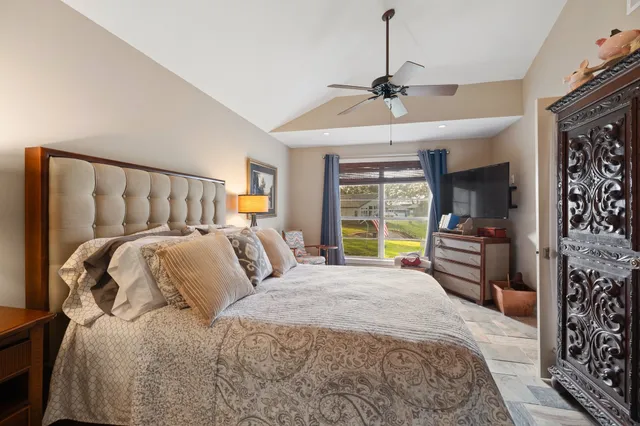 a bedroom with a large bed and a window