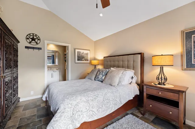 a bedroom with a bed and a lamp