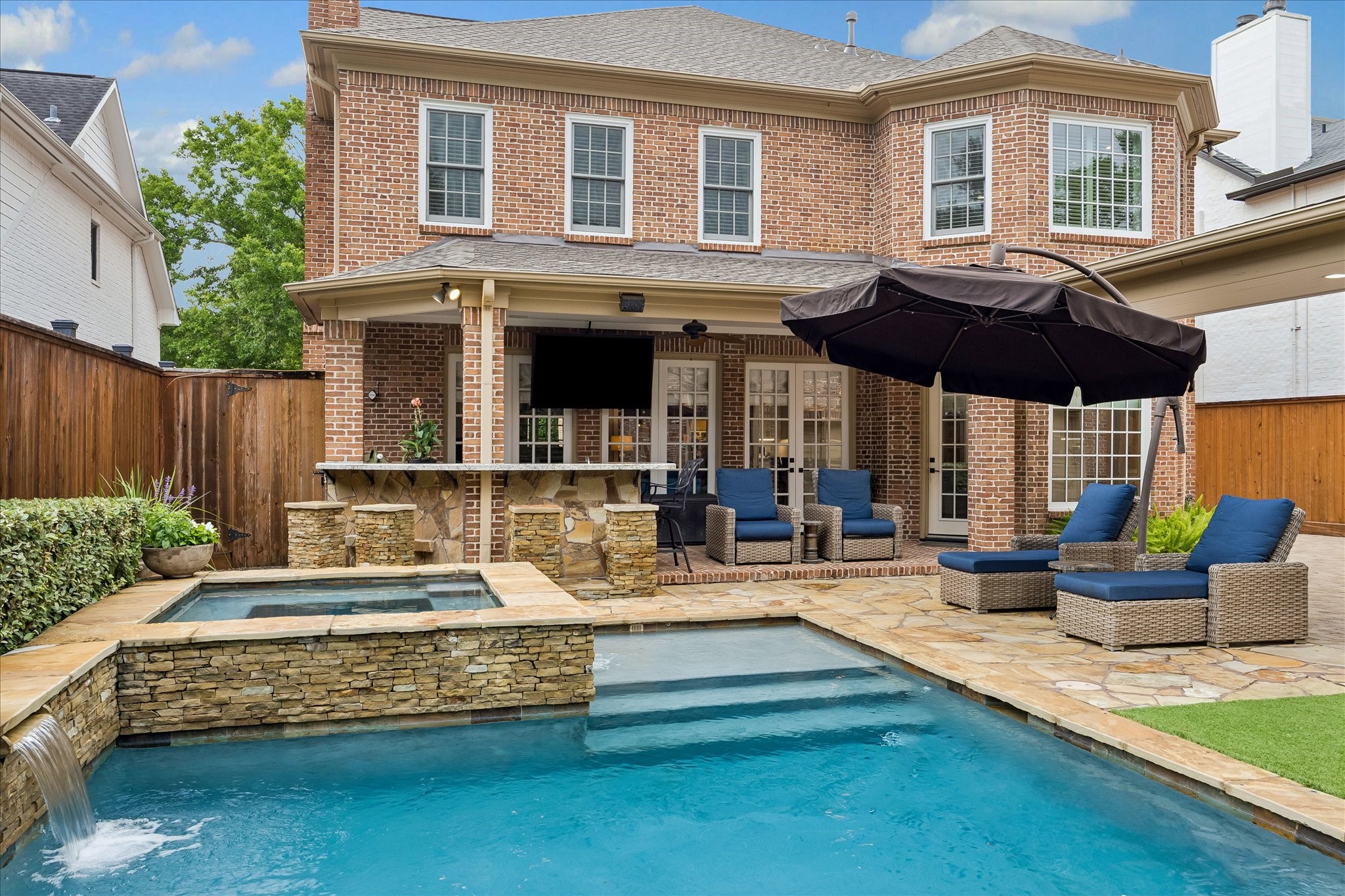 6358 Auden Street Houston, TX 77005 - Photo 41 of 50 Another view of spa/hot tub with waterfall features of pool. Double-paned windows were installed some years ago.