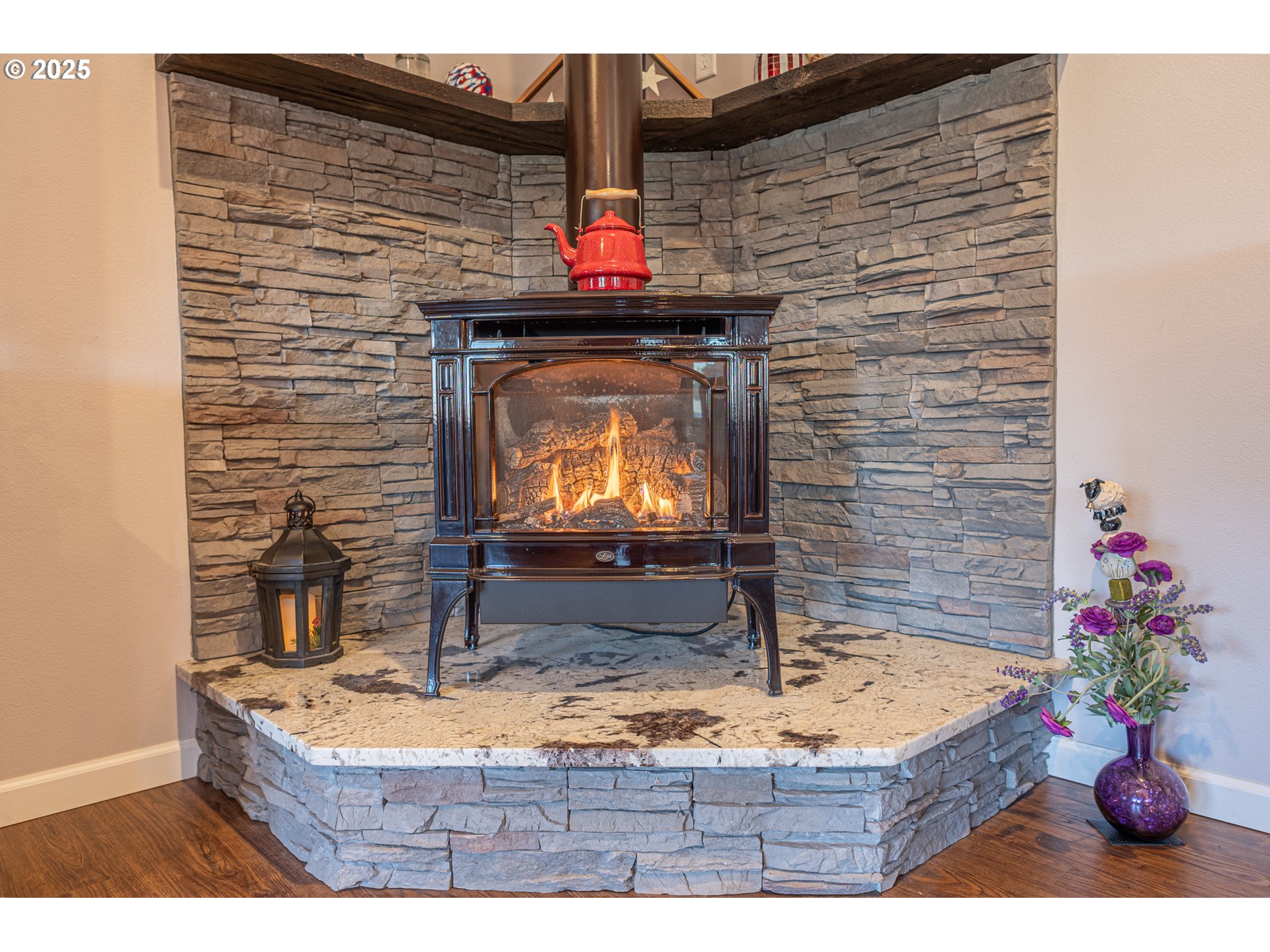 2686 Cedar Loop Bandon, OR 97411 - Photo 13 of 42 a living room with fireplace furniture and a potted plant