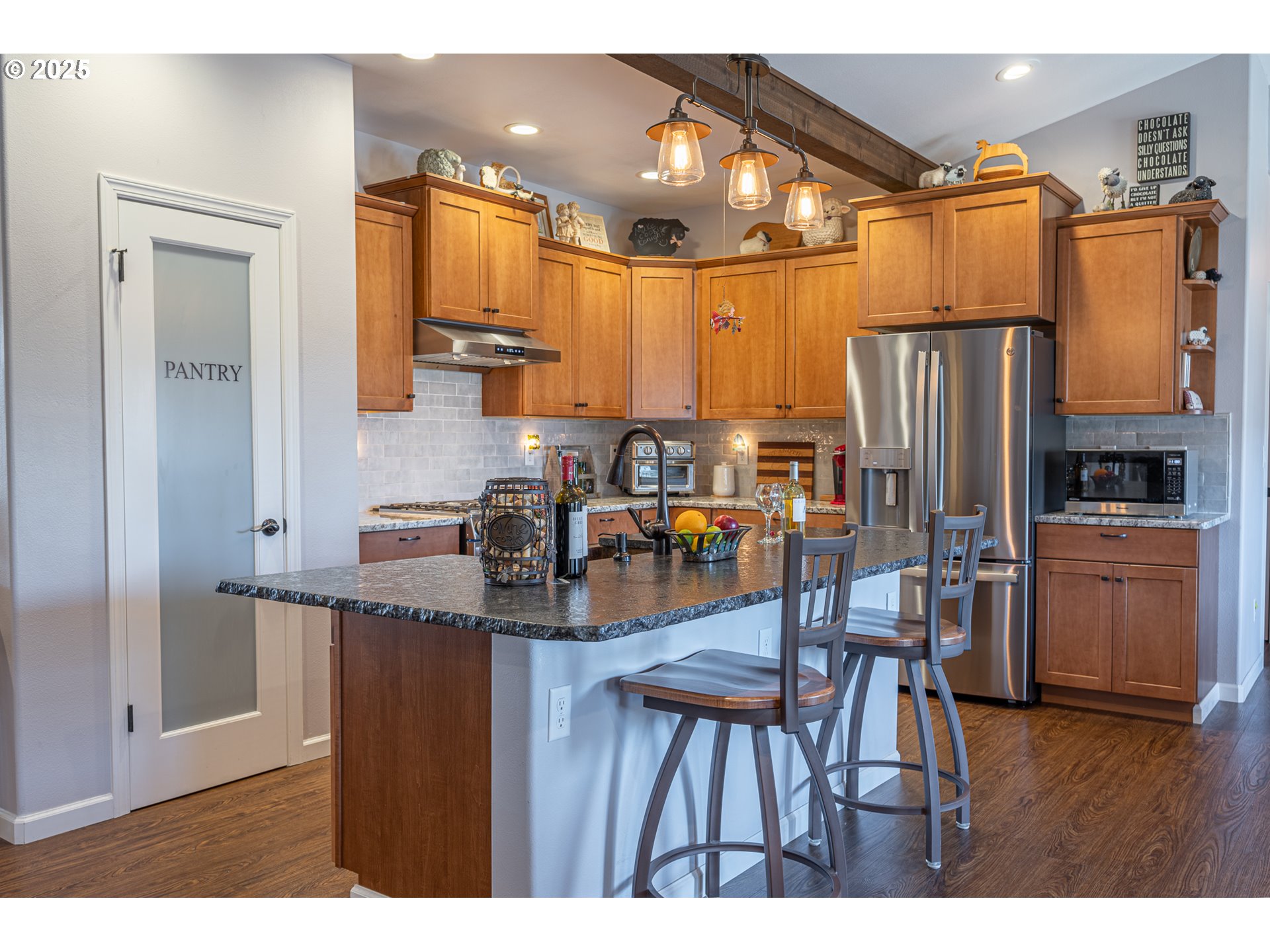 2686 Cedar Loop Bandon, OR 97411 - Photo 16 of 42 a kitchen with stainless steel appliances granite countertop a refrigerator a stove top oven a sink and dishwasher
