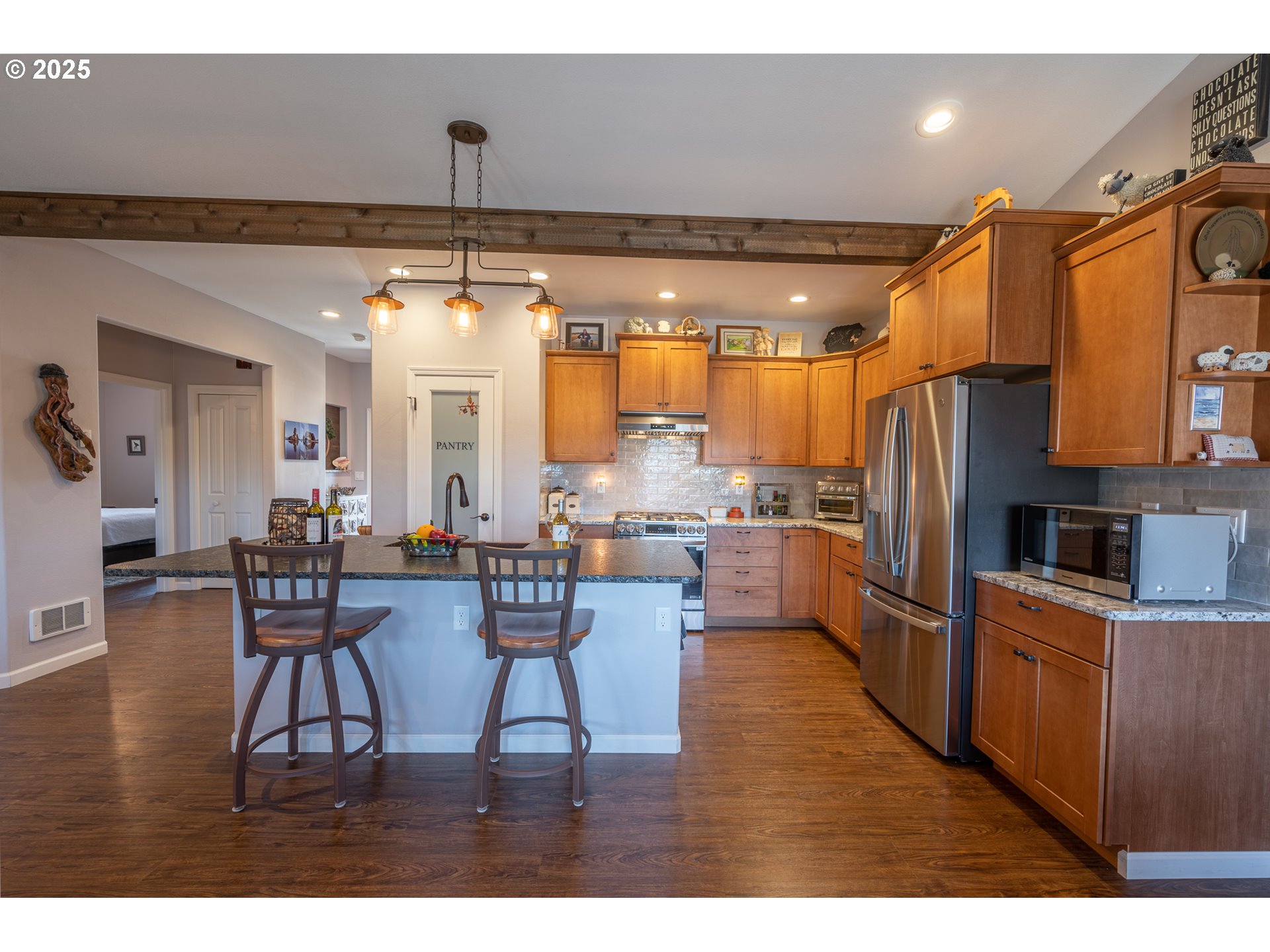 2686 Cedar Loop Bandon, OR 97411 - Photo 17 of 42 a view of a dining room with furniture window and wooden floor